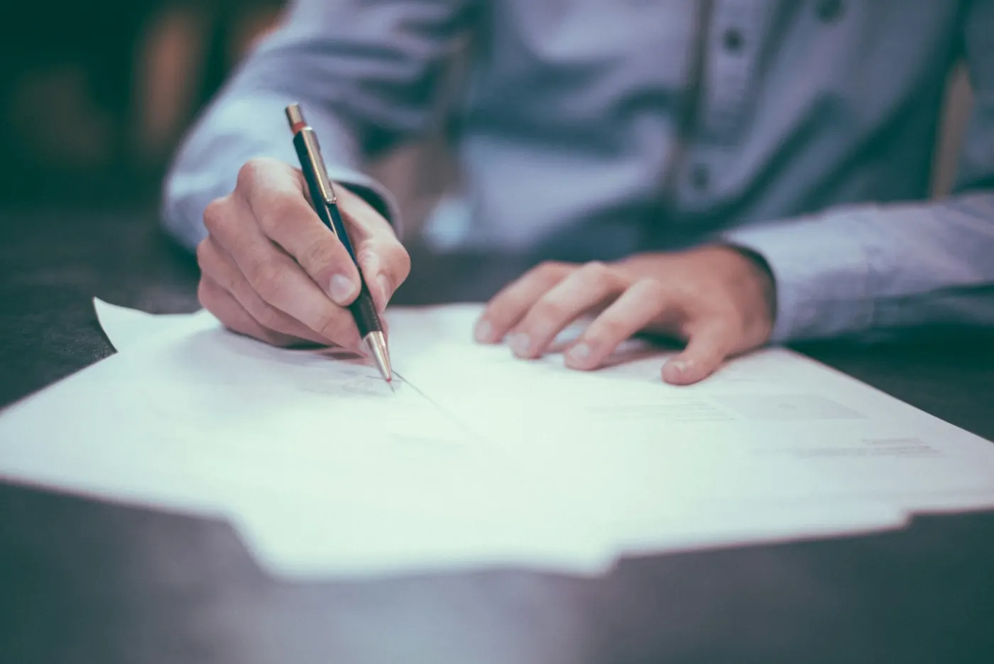 Alder & Quinn partners reviewing financial statements with a client